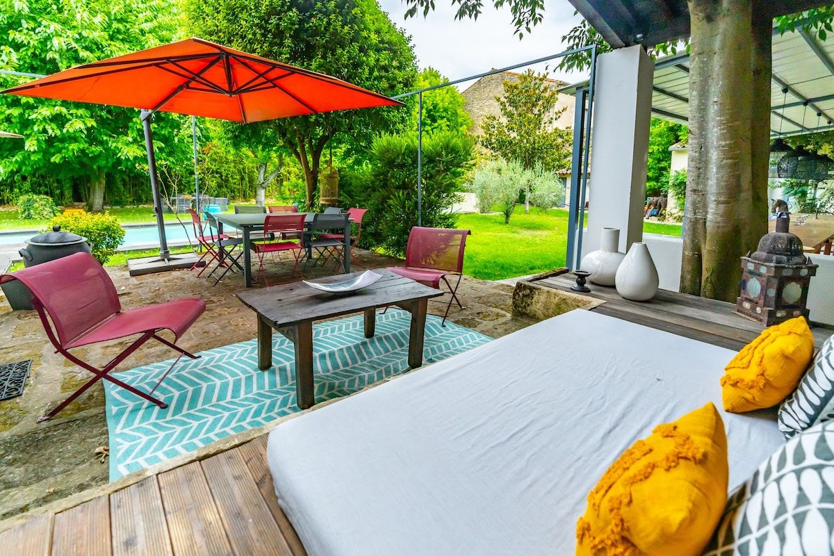 Shaded seating on the terrace under a red parasol